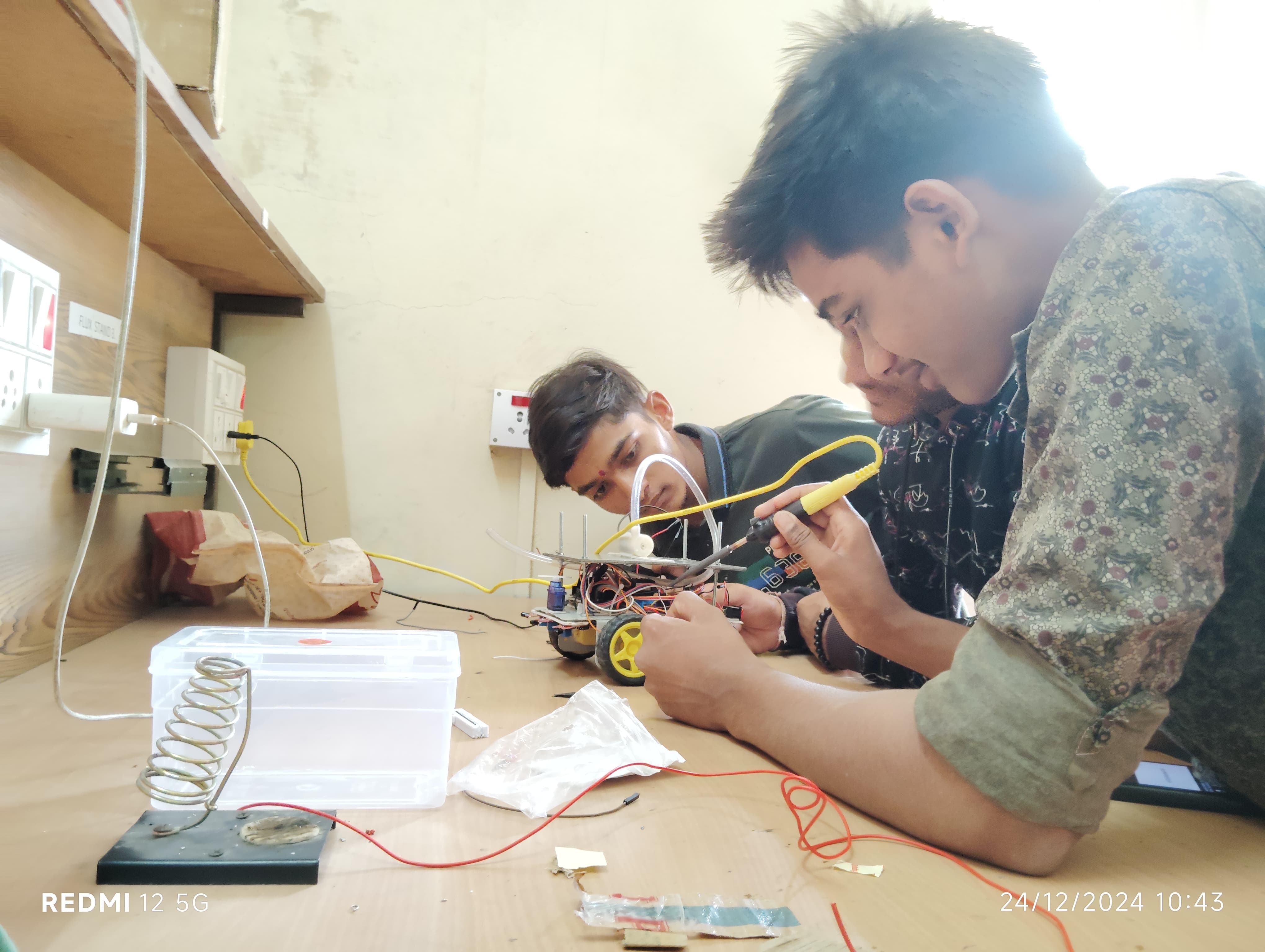 Electronics Mechanic trainees assembling a robotics project